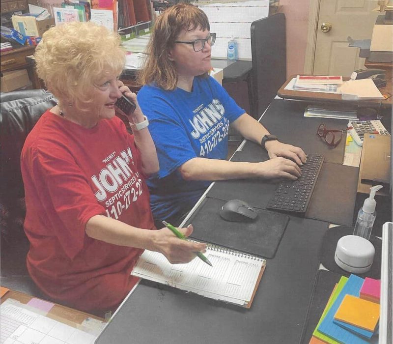 John’s Septic Service office staff assisting a customer with septic service scheduling in Maryland